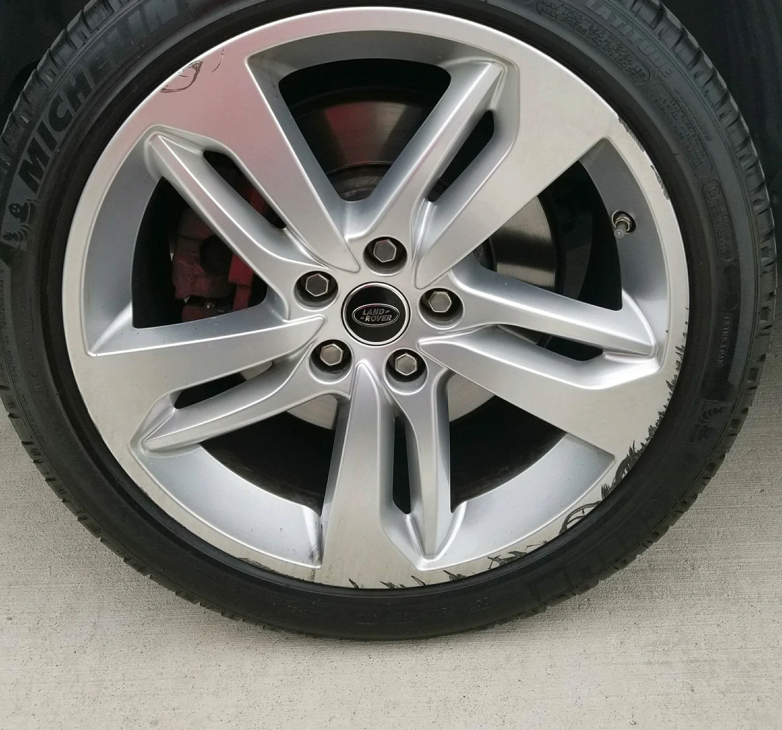 Land Rover — curb rash refinished. — before refinishing