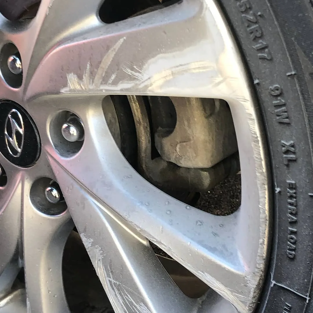 Hyundai — curb rash refinished. — before refinishing